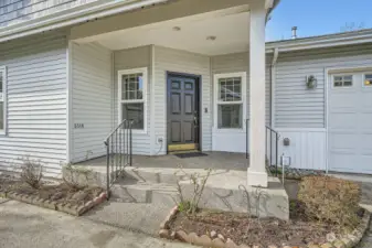 covered entry patio with guest parking just adjacent, oversized two car garage attached to unit