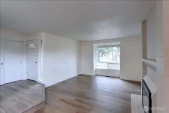 Living room - note newer vinyl windows and new flooring, millwork and paint throughout.