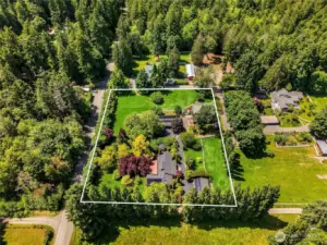 Welcome to the Bainbridge Dream! 2 sunny acres with flat green pastures, a lovely main home, a large carriage house, 3 stall barn with paddocks, a green house and a hen house!