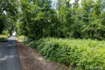 This flat property has water ran 600 ft away down this road or you could drill a well