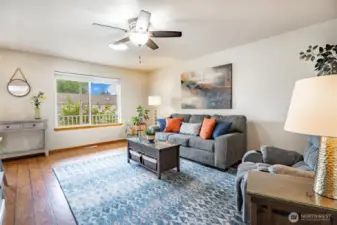Living Room features skylight and large picture window that looks out to a covered front porch and rose garden