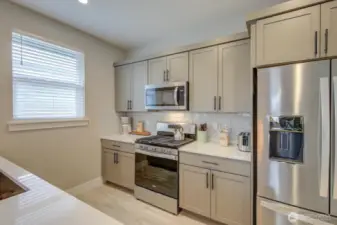 Soft-close cabinets, quartz countertops and stainless steel appliances.