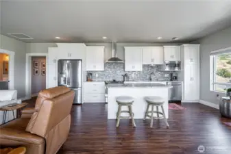 Kitchen with island open to dining and living areas