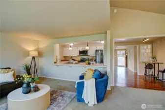 Great room looking towards kitchen, breakfast area and front entrance.