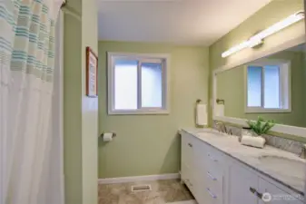Main full bathroom with tub/shower, double vanity located off of the front hall near the 3 bedrooms.