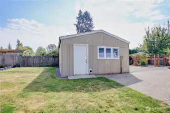 Storage shed/shop convenient to the driveway with an access gate, room to park RV on slab behind gate.