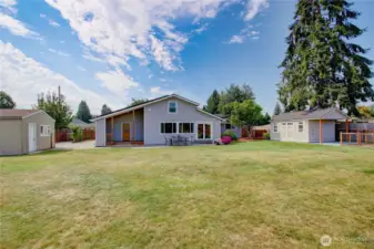 Backyard looking towards shed/shop, home, patio and newer outbuilding.  What a great yard!