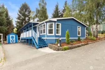 Charming manufactured home in Silverdale with fresh exterior paint, covered porch, and private driveway. Includes matching storage shed and landscaped front yard.