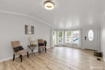 Welcoming entryway leading to a cozy living area, modern lighting, and a view of the front porch.