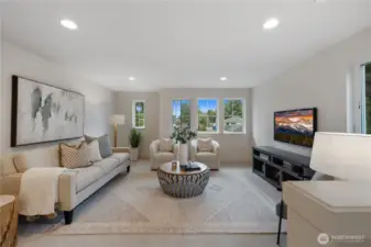 Primary bedroom with vaulted ceilings and large windows.