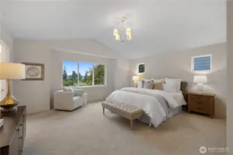 Primary bedroom with vaulted ceilings