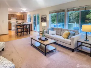 Open layout connects the family room to the kitchen and eating area, creating a great space for cooking, entertaining, and staying connected. Slider opens to the deck for easy al fresco dining with greenbelt views.