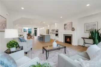 From the living area, the open concept design flows seamlessly toward the kitchen and dining space beyond.