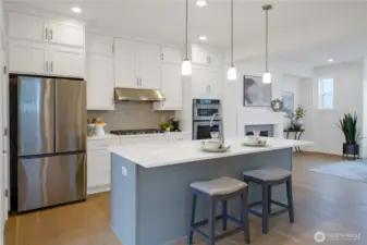 The kitchen shines with gorgeous quartz countertops and a striking backsplash tile that adds modern elegance.