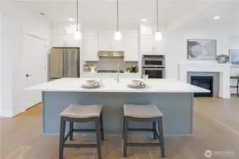 Expansive white cabinetry provides abundant storage, keeping the kitchen both practical and inviting