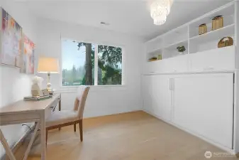 The first of two secondary bedrooms features a large closet and a built-in Murphy bed with additional storage.  This clever setup maximizes space, leaving plenty of room for an in-home office or guest retreat.