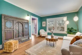 The living room connects to the entry with its open staircase and to the dining room for a practical, comfortable layout.