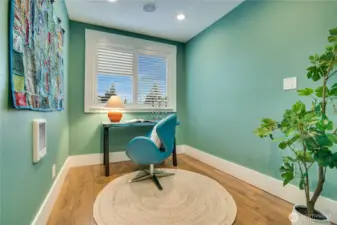 Take the single step down into this home office just beyond the bath and laundry. A door leads directly out to the deck in the fenced back yard.
