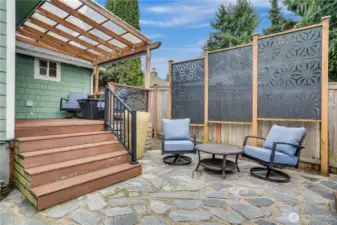 With an open patio and covered deck there's a place for sunshine and shade in this low-maintenance back area designed for relaxation.