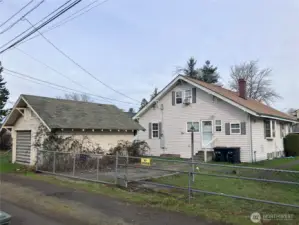 Back of main home and detached garage