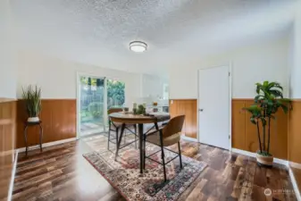 Spacious open, flowing space with original paneling, chair rail and unfettered views of the property's exterior. Pictured is the pantry in this formal dining area
