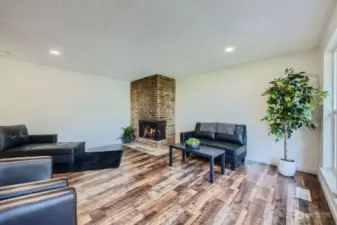 Floor to ceiling, corner brick Gas fireplace with slate hearth will keep this room warm & cozy