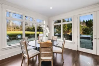 Kitchen Eating Nook Offers A Wall Of Windows And French Doors Allowing Views And Access To The Gorgeous Backyard.