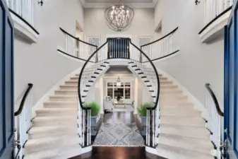 A Dramatic Entrance To A Stunningly Beautiful Home. Two-Story Foyer Features A Double Staircase, Juliet Balconies, Custom Lighting And Gleaming Hardwood Floors.