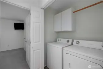 Utility closet with washer and dryer.