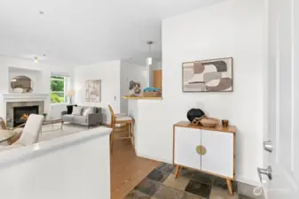 Welcoming entry with natural flow into the open living and dining areas, featuring comforting slate and vinyl plank floors, cozy fireplace, and abundant natural light.