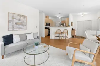 Open-concept family room flows to the kitchen with breakfast bar seating, plus a spacious entry closet for added storage.