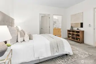 Expansive primary bedroom with ample space, newly integrated lighting with Casetta remote switches, and direct access to a walk-in closet and ensuite bath with dual sinks.