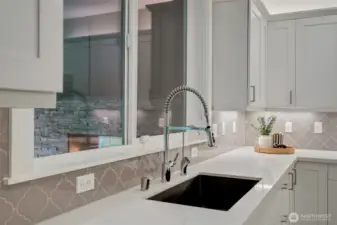 Sleek undermount sink with designer tile backsplash