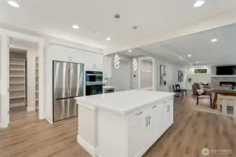 Large center island anchors the kitchen and encourages gathering and conversation, room for stools