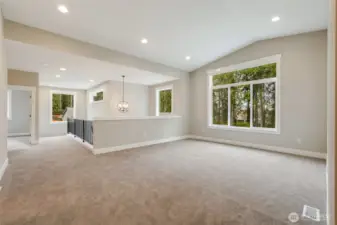 flexible, bright, and luxurious, Oversized bonus room upstairs with vaulted ceiling and tree-lined views — a space that adapts to your lifestyle.”
