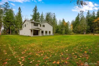 1.± acre estate setting, Wide-open usable yard—ideal for pets & play, framed  by towering evergreens for year-round beauty
