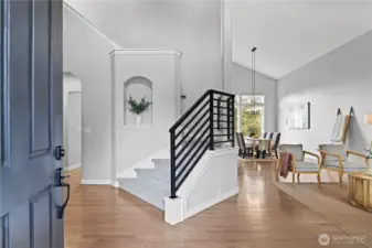 Grande entry with towering ceilings and custom stair rail