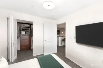 Bedroom features a walk-in closet with custom shelving