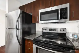 Kitchen features stainless steel appliances & granite counters