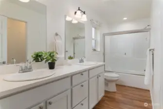 Two sinks in primary bath with the same quartz counter top as the kitchen.