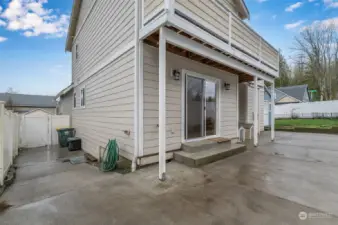 West side yard with the door leading to kitchen.