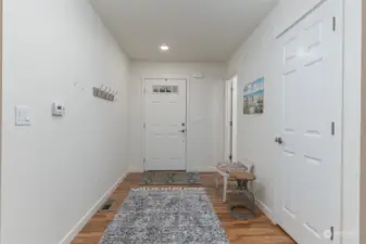 Looking toward the entry door there is a closet and half bath on the right.