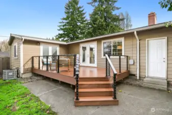 New TREX deck with powder-coated steel railing. Door on right leads to oversized 1-car garage