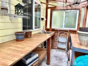 Potting room w/ bench and sink attached to shop w/ own entrance.