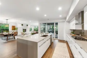 The Chef's kitchen is a culinary masterpiece, featuring high-end stainless steel appliances, quartz countertops, and a generous center island with bar seating. at its best.