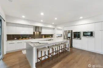 Plenty of extra seating at the beautiful island. Stunning quartz countertops.