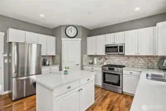 Kitchen boasts stainless steel appliances and quartz counter tops