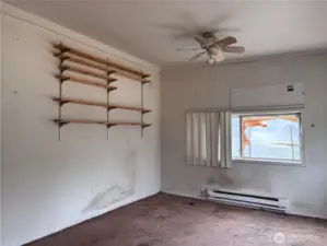 The bedroom has a ceiling fan
