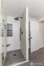 Large, walk-in shower with beautiful tile work.