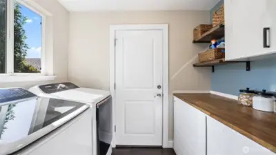Enjoy built-in shelving and counter space, making laundry days effortless.